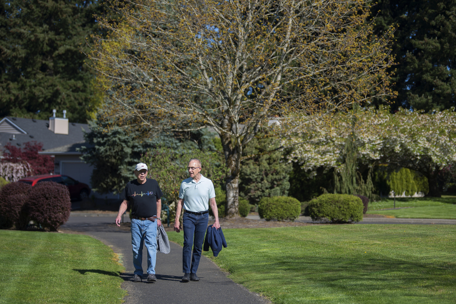 Richard Moody, 75, left, and his husband, Carl Caspersen, walk near their home in southeast Vancouver. Moody, who has lived 26 years with a transplanted heart, is careful to lead a healthy lifestyle and walks daily.