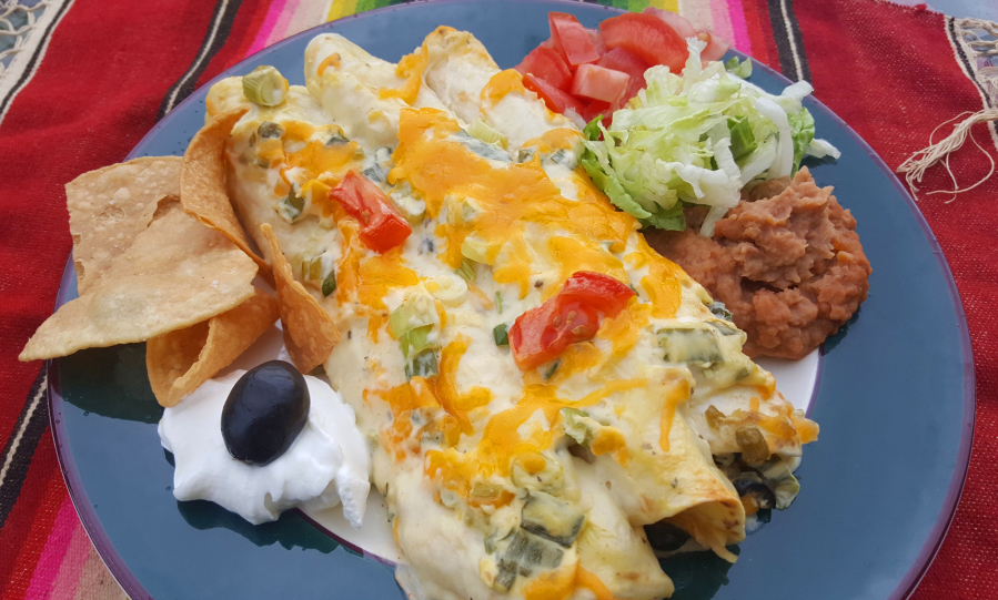 These creamy chicken enchiladas use chicken soup and sour cream for a cheesy, chicken-y enchilada, with savory flavor from green onions.