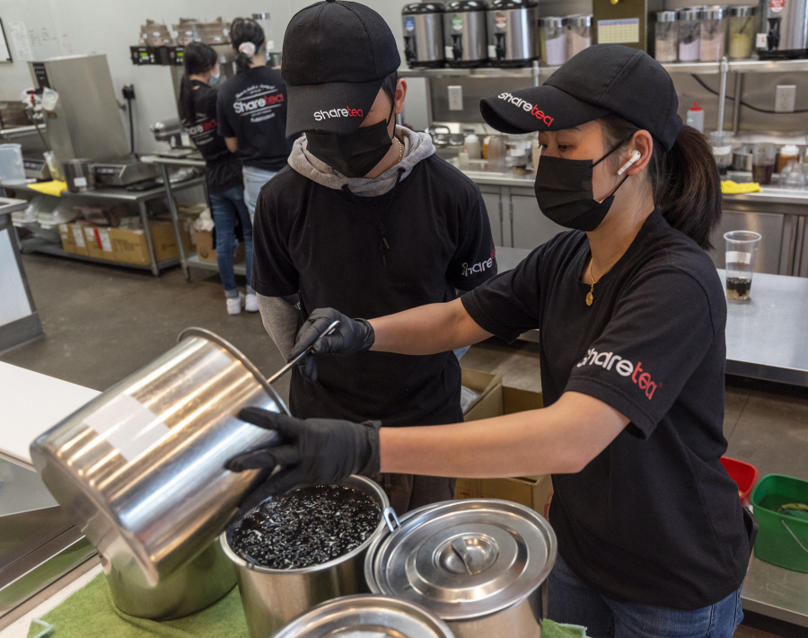 Sharetea owner NaNa Sisakvanich, right, combines vats of black tapioca pearls while Tyme Sisakvanich watches at Sharetea in Hazel Dell. A global shortage in the ingredients that make up the tapioca pearls in boba tea is affecting businesses that serve the colorful drinks.