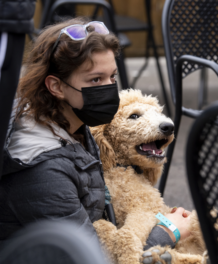 Vancouver resident Grace Wasser and poodle Archie pause at the Heathen Brewing Feral Public House in downtown Vancouver on Saturday during the Humane Society for Southwest Washington's fundraising event.