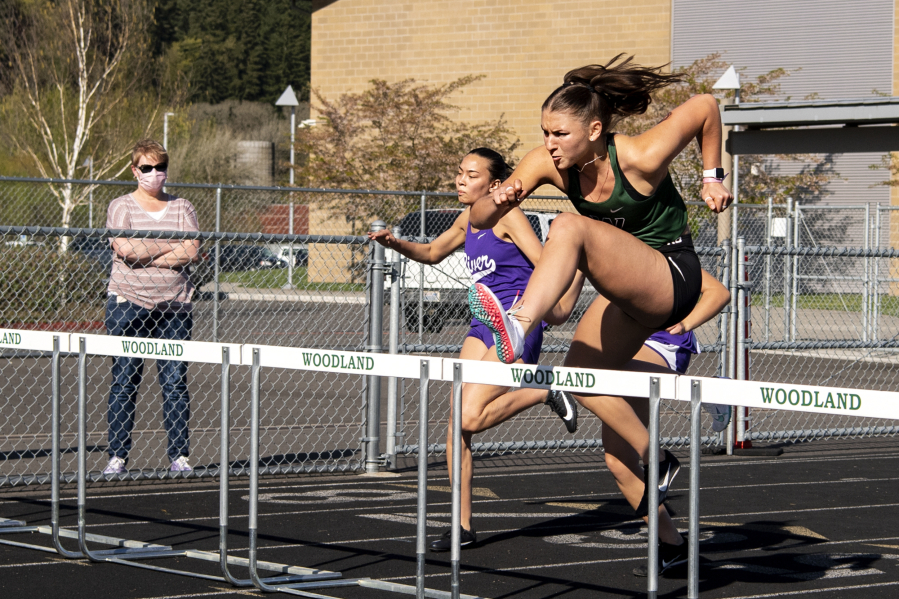 Woodland senior Lucy George clears a hurdle in the 100-meter hurdles at a 2A Greater St. Helens League track meet on  April 15 at Woodland High School. George, a Grand Canyon University track and field commit, hasn't lost an event this season - she has competed in the long jump, high jump, hurdles, javelin and shot put - and has a Division I collegiate spot locked up. But while others see athletic success, George struggles to find confidence in herself. She still battles with body image issues and grapples daily with overcoming an eating disorder that stemmed from a past coach telling her she needed to lose weight.