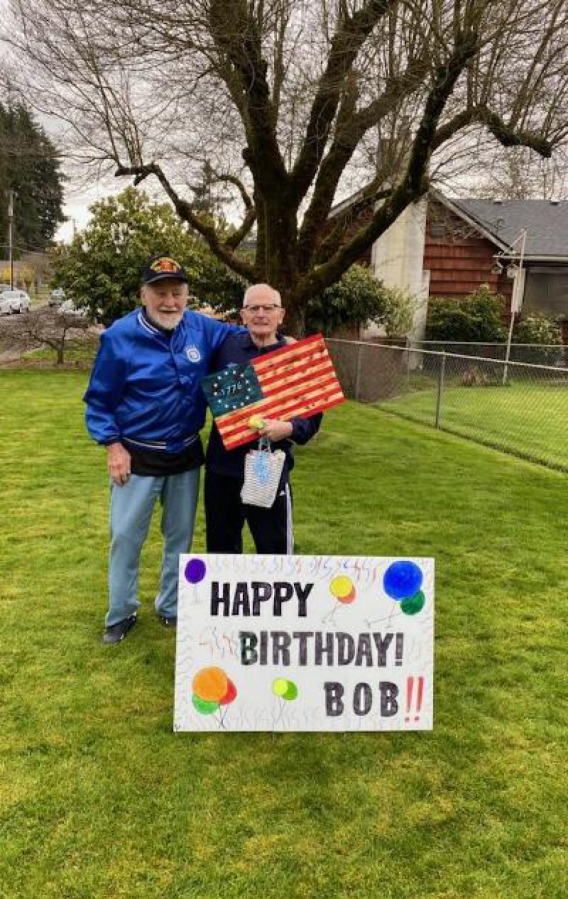 WASHOUGAL: At left is Bob Rodgers with Robert "Bob" Peake, holding the wooden flag that was presented to Peake on his 90th birthday by the Patriot Guard.