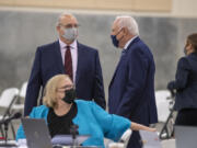Plaintiffs Chris Clifford, clockwise from left, Don Benton and Susan Rice pause to talk during a break from the lawsuit trial Wednesday at the Clark County Event Center at the Fairgrounds.