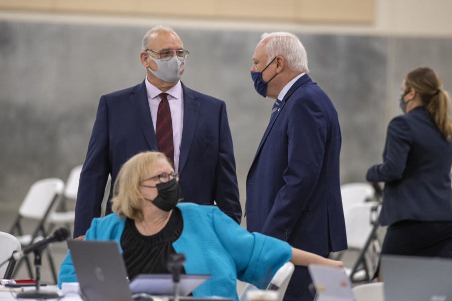 Plaintiffs Chris Clifford, clockwise from left, Don Benton and Susan Rice pause to talk during a break from the lawsuit trial Wednesday at the Clark County Event Center at the Fairgrounds.