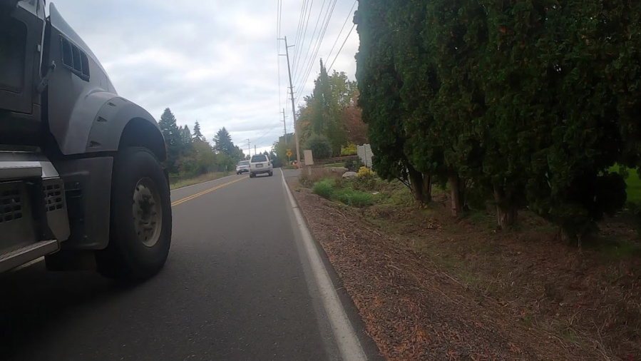 This bike-view photo of a near-miss on Northwest Seward Road shows just how closely some drivers pass beside cyclists in the roadway who have nowhere else to go - no shoulder or bike lane. A 2020 state law requires that drivers give cyclists in the road at least 3 feet of space, if not a whole lane.