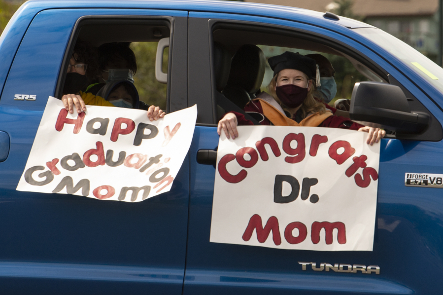 Diane Marines celebrates with her family after receiving her doctorate during Saturday's drive-thru graduation for Washington State University Vancouver. The school held a drive-thru ceremony in August after the COVID-19 pandemic had derailed the traditional spring ceremony, but this year's event took place on the actual graduation date.