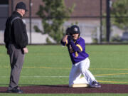 Columbia River’s Jordan Wiggins claps toward his team’s dugout after a double in a 2A Southwest District Tournament third-place game on Friday, May 7, 2021, at the Ridgefield Outdoor Recreation Complex. Columbia River won 3-2 over Washougal in eight innings.