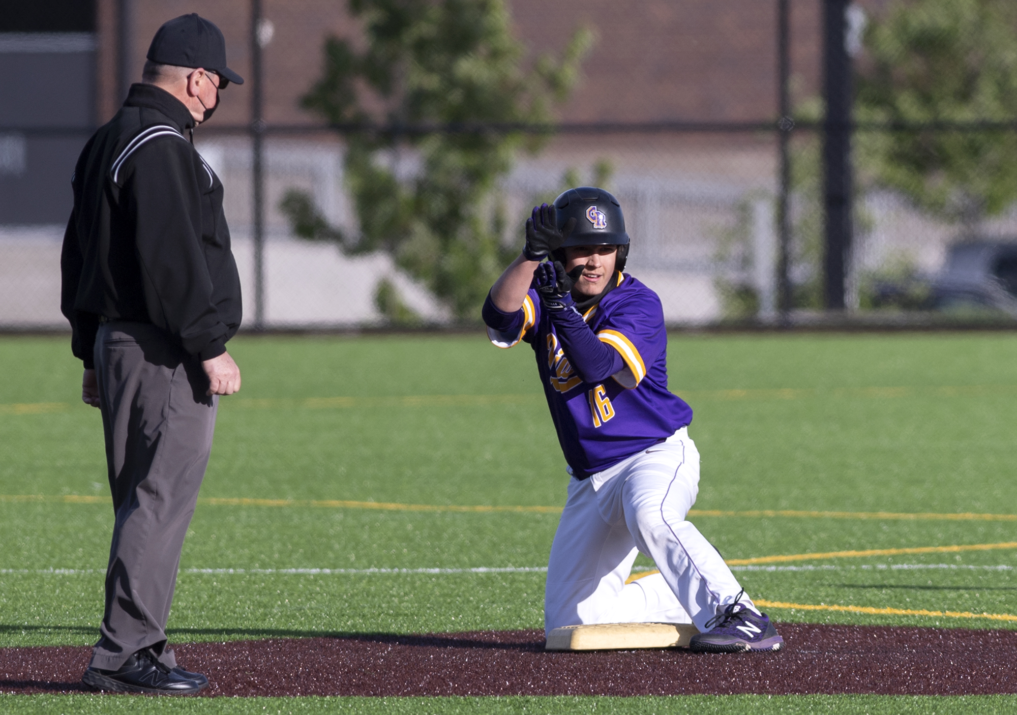 Columbia River’s Jordan Wiggins claps toward his team’s dugout after a double in a 2A Southwest District Tournament third-place game on Friday, May 7, 2021, at the Ridgefield Outdoor Recreation Complex. Columbia River won 3-2 over Washougal in eight innings.