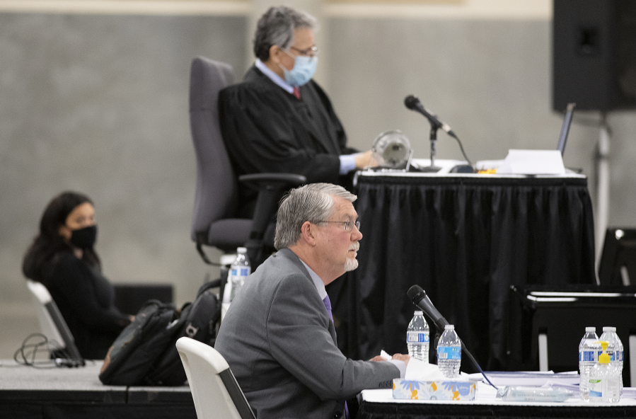 Former Clark County manager Mark McCauley, center, testifies Monday in the trial for a lawsuit brought by Don Benton against the county as Superior Court Judge Gregory Gonzales, top, looks on at the Clark County Event Center at the Fairgrounds.
