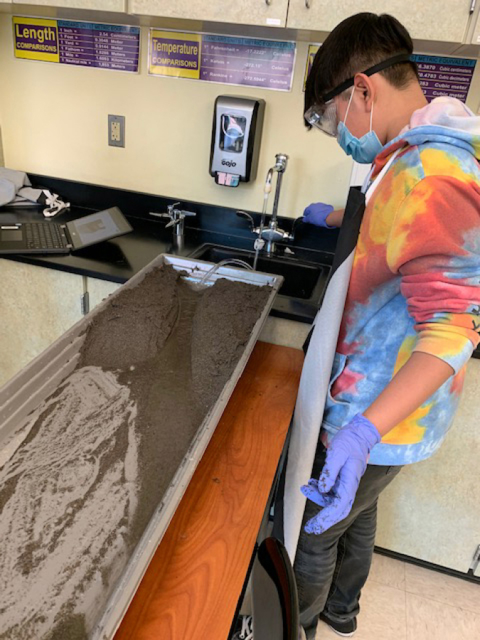 ORCHARDS: Eighth-grade students at Covington Middle School use stream tables purchased by Pharmaceutical Research and Manufacturers of America in a STEM lab lesson about erosion.