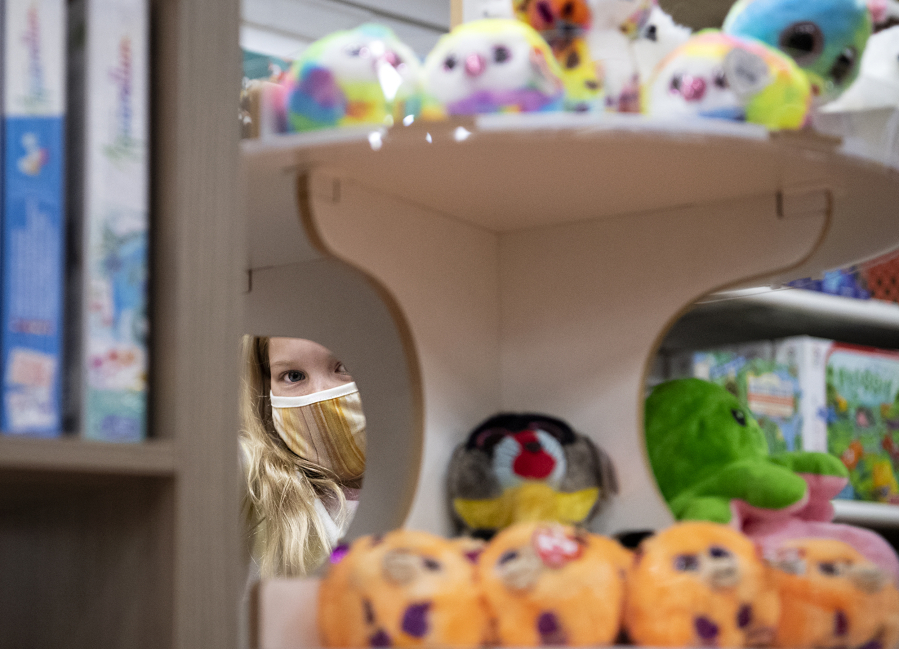 Brooklyn Feustel looks through the selection at Kazoodles Toys in Vancouver. The toy store is one of many small businesses in Clark County that received Paycheck Protection Program loans last year. Local lenders have now turned to guiding their clients through the loan forgiveness process.