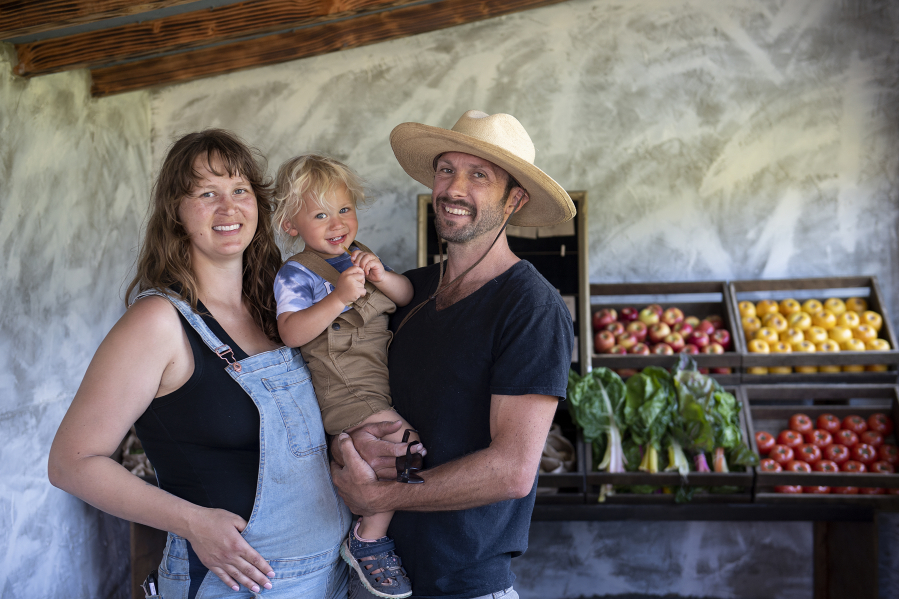MacKenzie Krumhauer, 28, son, Oliver, 1 1/2 , and her husband, Sean, enjoy their new home at Thiselle Creek Farm in Yacolt. The family moved from Southern California in 2018 due to a wildfire destroying their previous land.  ""We can learn from other mistakes to make it so we're working in symbiosis with the environment rather than pushing back," MacKenzie said.