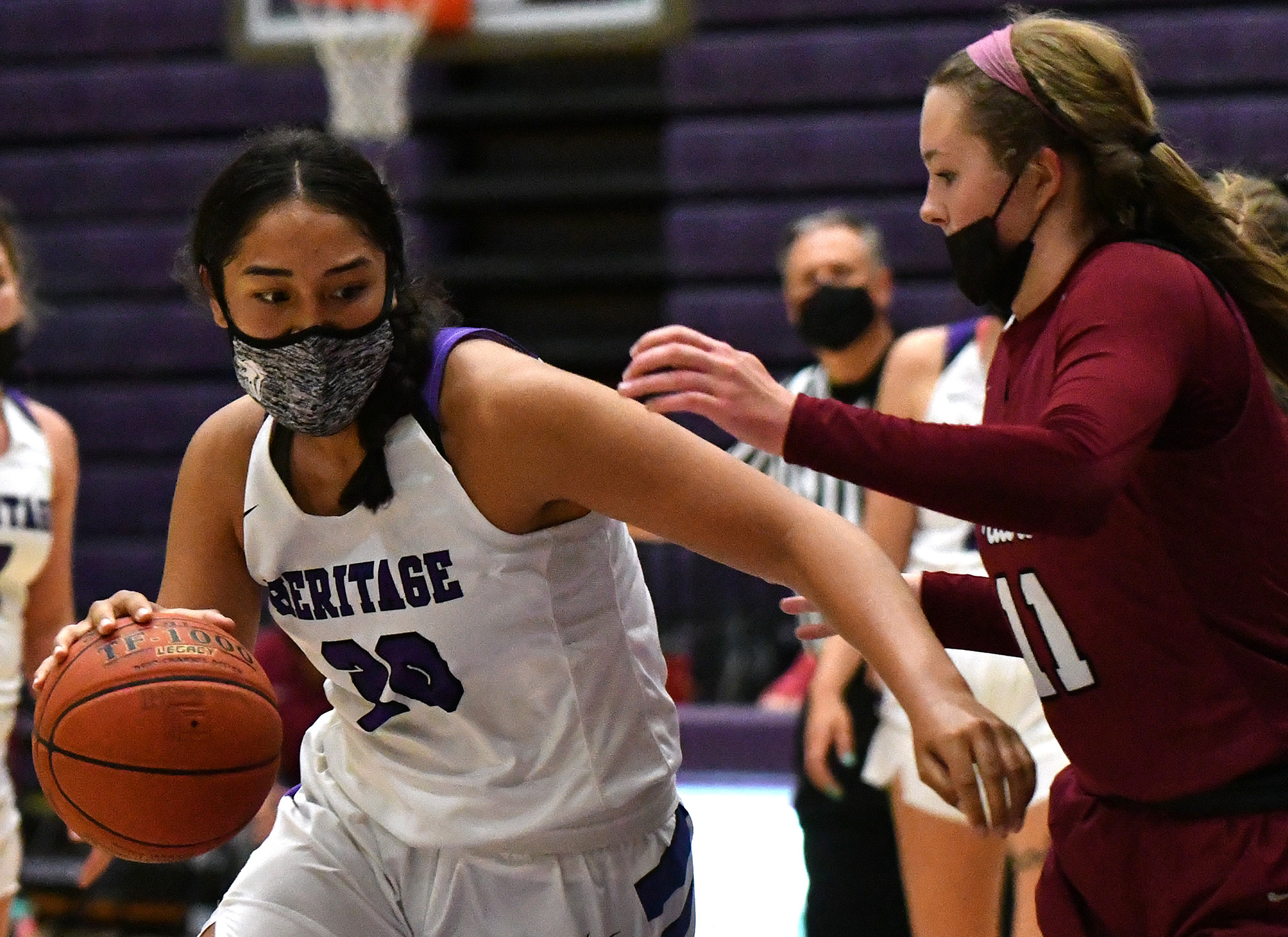 Heritage senior Katie Peneueta weaves toward the basket Thursday, May 20, 2021, during the Timberwolves’ 53-42 win against the Falcons at Heritage High School in Vancouver.