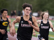 Union freshman Grayson Caldwell hustles his way down the back straight of the 400-meter race in a 4A/3A Greater St. Helens League dual on Tuesday, May 25, 2021, at Union High School. Caldwell finished second with a personal-best 52.82-second mark.
