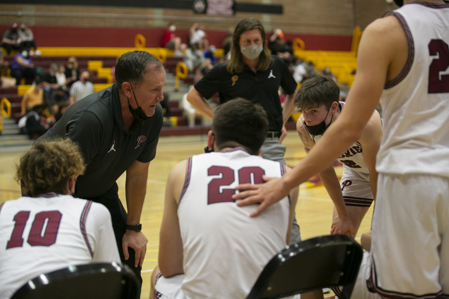 Prairie's head coach Kyle Brooks talks to his players after the first quarter against Mountain View on Wednesday at Prairie High School. Even though Mountain View won this game 66-57, Brooks will leave the Falcons with more than 360 victories, seven league titles and many trips to state.