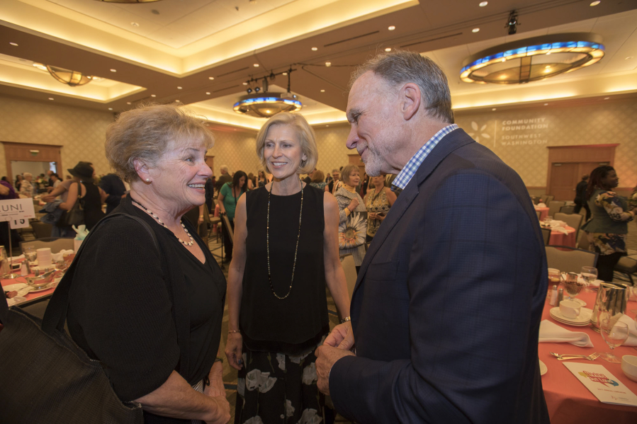 Vancouver resident Jane Jacobsen, from left, congratulates Michele and Greg Goodwin at an event at the Hilton Vancouver Washington in June 2017.