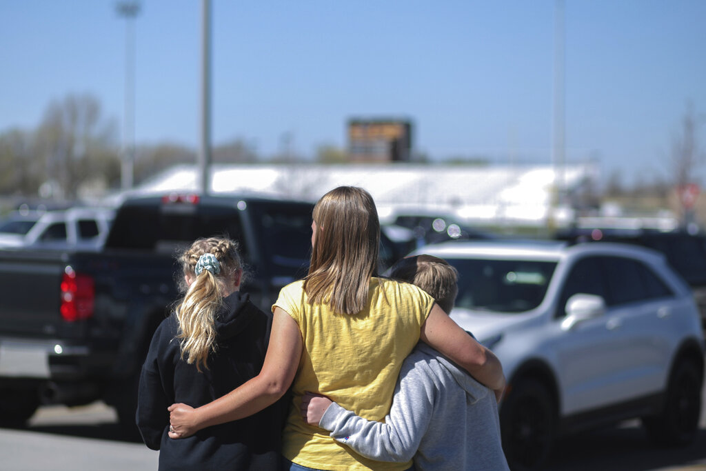 People embrace outside after a shooting at Rigby Middle School in Rigby, Idaho on Thursday, May 6, 2021.  Authorities say a shooting at the eastern Idaho middle school has injured two students and a custodian, and a male student has been taken into custody.