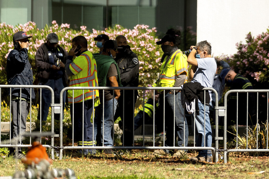 Santa Clara Valley Transportation Authority (VTA) workers gather near a railyard following a shooting on Wednesday, May 26, 2021, in San Jose, Calif. Santa Clara County sheriff's spokesman said the railyard shooting left multiple people, including the shooter, dead.