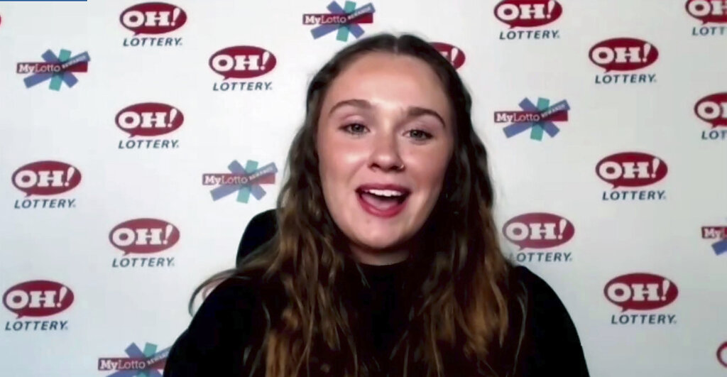 In this still image, taken from video by the Office of the Ohio Governor, Abbigail Bugenske, 22, from Cincinnati, the first winner of Ohio's first $1 million Vax-a-Million vaccination incentive prize, is interviewed during a news conference, Thursday, May 27, 2021.
