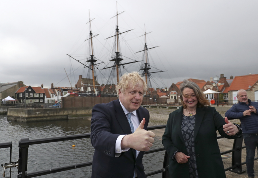 British Prime Minister Boris Johnson poses for photographers with Jill Mortimer, the winning Conservative Party candidate of the Hartlepool by-election, at Hartlepool Marina, in Hartlepool, north east England, Friday, May 7, 2021. Britain's governing Conservative Party made further inroads in the north of England on Friday, winning a by-election in the post-industrial town of Hartlepool for a parliamentary seat that the main opposition Labour Party had held since its creation in 1974.