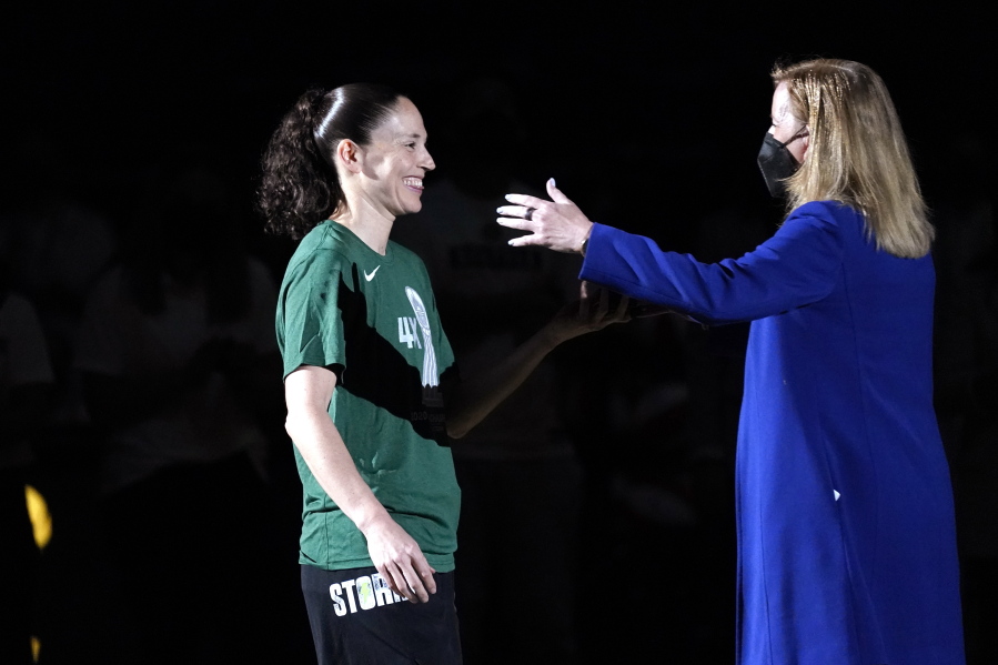 Seattle Storm's Sue Bird, left, is greeted by WNBA commissioner Cathy Engelbert during a championship ring ceremony before a WNBA basketball game against the Las Vegas Aces, Saturday, May 15, 2021, in Everett, Wash.