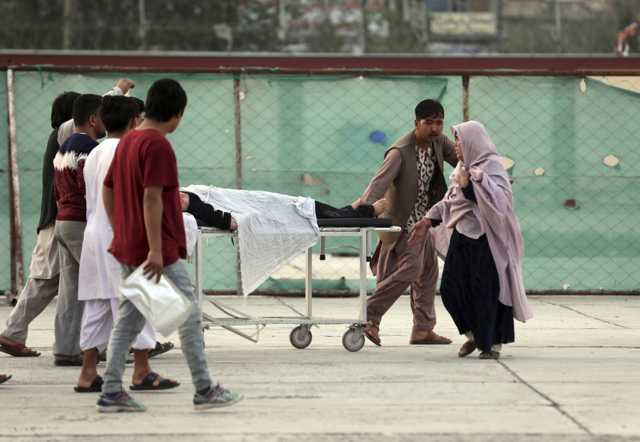 An injured school student is transported to a hospital after a bomb explosion near a school west of Kabul, Afghanistan, Saturday, May 8, 2021. A bomb exploded near a school in west Kabul on Saturday, killing several, many them young students, Afghan government spokesmen said.