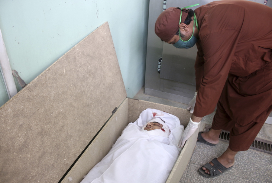 The body of Nimat Rawan, a former Afghan TV presenter, lies in morgue at a hospital in Kandahar, Afghanistan, Tuesday, May 6, 2021. Gunmen killed Rawan on Thursday as he was traveling in the southern city of Kandahar, a provincial official said, adding to fears for press freedom in the war-wrecked country.