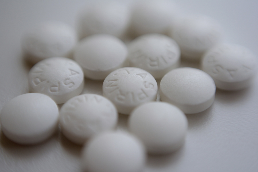 FILE - This Aug. 23, 2018 file photo shows an arrangement of aspirin pills in New York. A large study finds that low-dose and regular-strength aspirin seem equally safe and effective for preventing additional heart problems in people who already have heart disease.