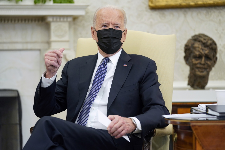 President Joe Biden snaps his fingers as he responds to a reporters question during a meeting with congressional leaders in the Oval Office of the White House, Wednesday, May 12, 2021, in Washington.