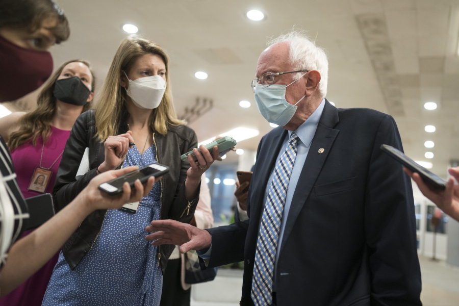 Sen. Bernie Sanders, I-Vt., chair of the Senate Budget Committee, pauses for reporters on Capitol Hill in Washington, Thursday, April 29, 2021, the day after President Joe Biden addressed Congress on his first 100 days in office. (AP Photo/J.
