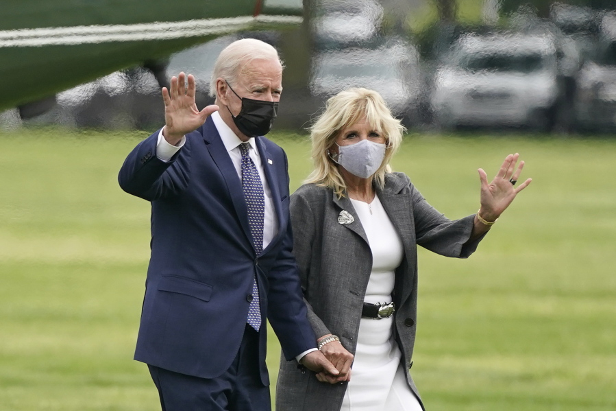 President Joe Biden and first lady Jill Biden wave after stepping off Marine One on the Ellipse near the White House, Monday, May 3, 2021, in Washington.  The Biden's traveled Monday to coastal Virginia to promote his plans to increase spending on education and children, part of his $1.8 trillion families proposal announced last week.