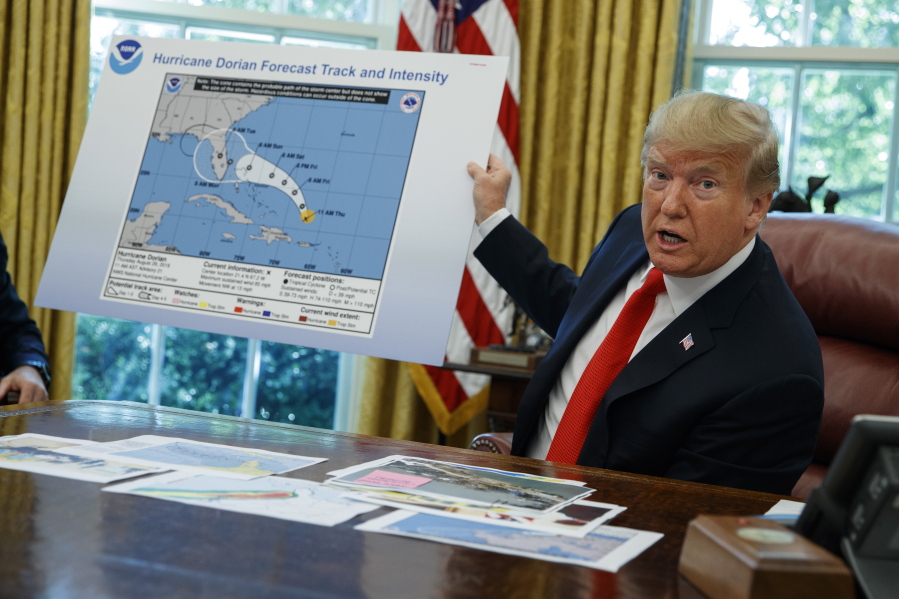 FILE - In this Wednesday, Sept. 4, 2019, file photo, President Donald Trump talks with reporters after receiving a briefing on Hurricane Dorian in the Oval Office of the White House, in Washington. A new 46-person federal scientific integrity task force with members from dozens of government agencies will meet for the first time Friday, May 14, 2021. During Sharpiegate, NOAA reprimanded some meteorologists for tweeting that Alabama was not threatened by the hurricane, contradicting the president, who said Alabama was in danger.