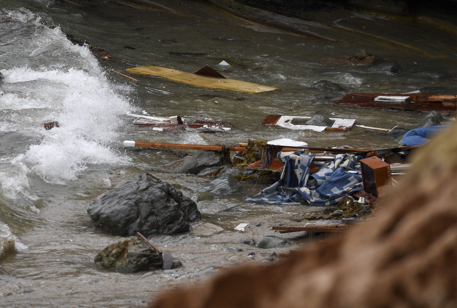 Wreckage and debris from a capsized boat washes ashore at Cabrillo National Monument near where a boat capsized just off the San Diego coast Sunday, May 2, 2021, in San Diego.
