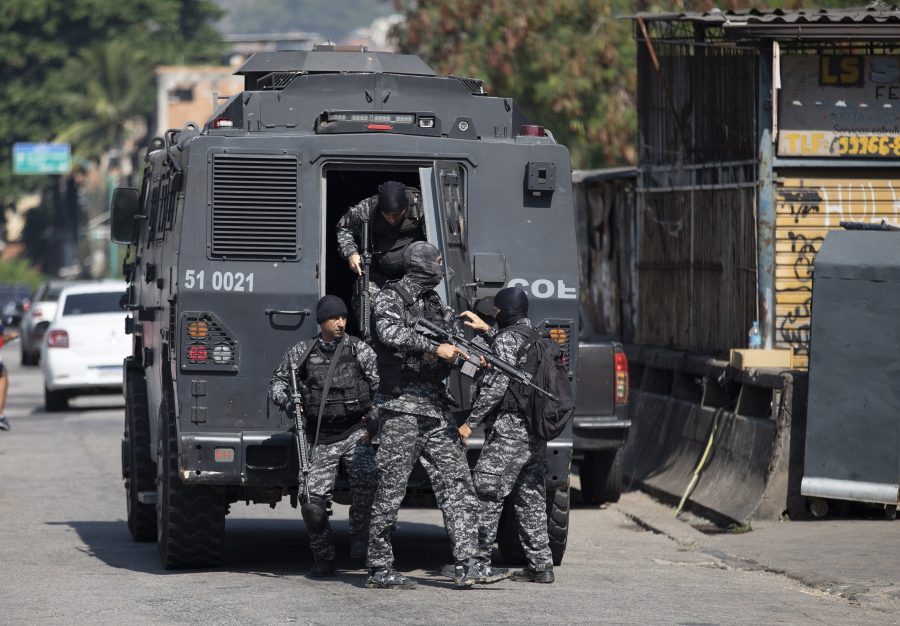 Police get out of an armored vehicle during an operation against alleged drug traffickers in the Jacarezinho favela of Rio de Janeiro, Brazil, Thursday, May 6, 2021.