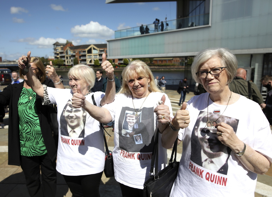 FILE - In this Tuesday May 11, 2021 file photo, family members of Frank Quinn react after the inquest in Belfast, Northern Ireland. U.K. government minister, Northern Ireland Secretary Brandon Lewis, stood before lawmakers on Thursday May 13, 2021, and formally apologized for the killing of 10 civilians during unrest in Belfast half a century ago, as Britain and Northern Ireland struggle to come to terms with the events of the past.