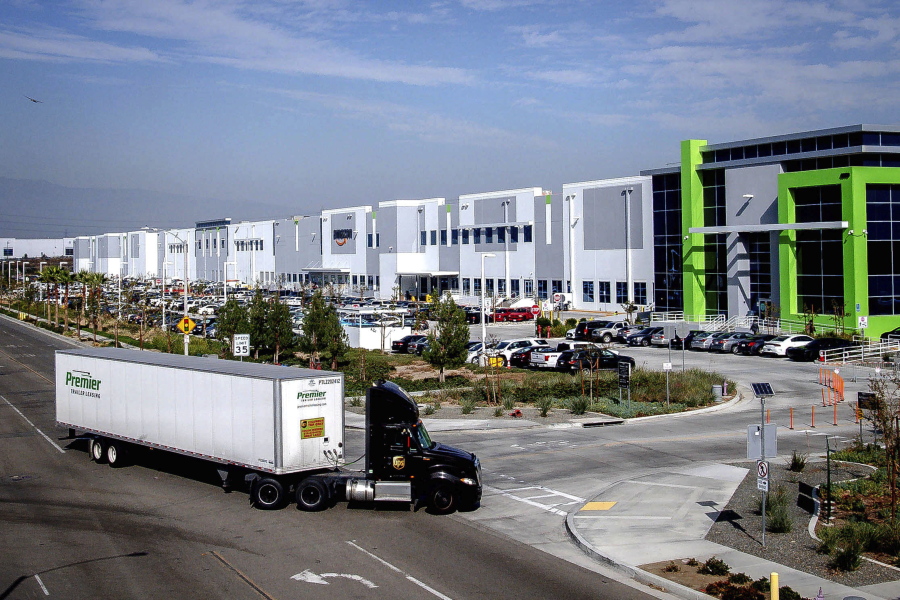 A semi-truck turns into an Amazon fulfillment center in Eastvale, Calif., in November. Air-quality regulators have approved a rule that would curb diesel emissions caused by the growing number of massive warehouses.