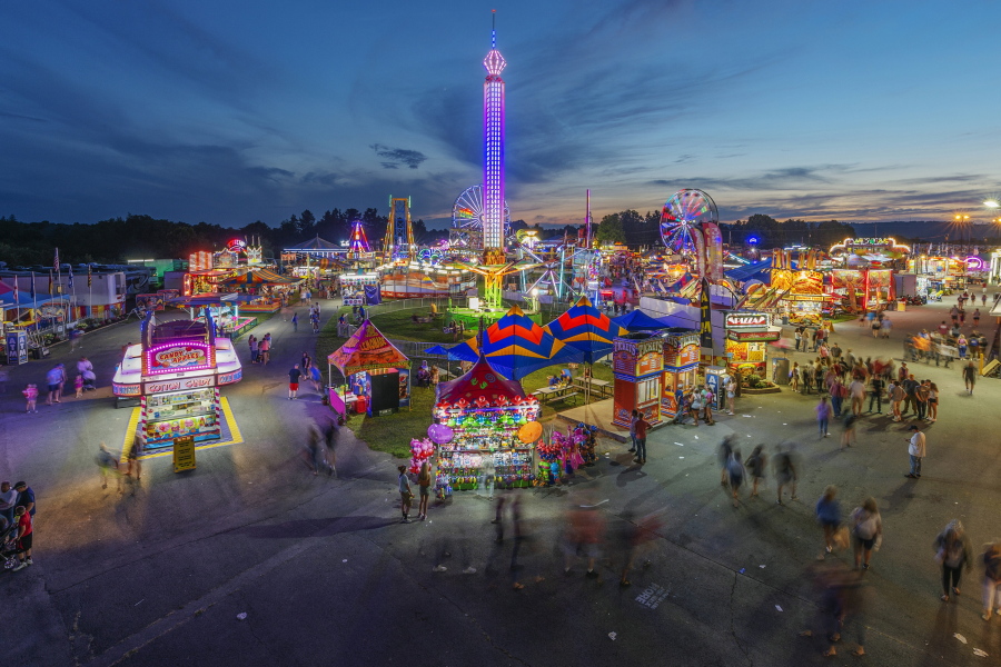 FILE - In this Aug. 9, 2018, file photo, fair-goers attend The State Fair of West Virginia at the State Fairgrounds in Fairlea, W.Va. West Virginia has seen a higher percentage of residents depart than any other state in the past decade.