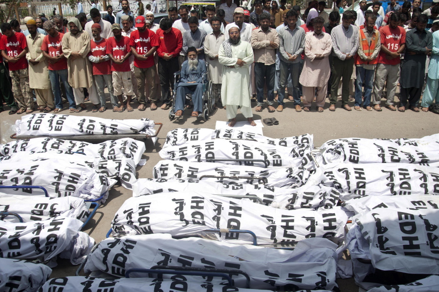 FILE - In this Friday, June 26, 2015 file photo, mourners attend a funeral for unclaimed people who died of extreme weather, in Karachi, Pakistan, after a devastating heat wave that struck southern Pakistan the previous weekend, with over 800 confirmed deaths according to a senior health official. A study published in Nature Climate Change on Monday, May 31, 2021, has calculated that more than one-third of global heat deaths can directly be attributed to human-caused climate change.