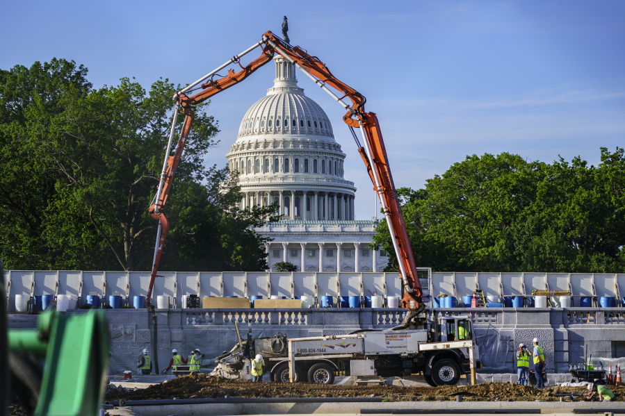 A concrete pump frames the Capitol Dome during renovations and repairs to Lower Senate Park on Capitol Hill in Washington, Tuesday, May 18, 2021. President Joe Biden hopes to pass a massive national infrastructure plan by this summer but Democrats and Republicans in Congress appear divided over his proposal for $2.3 trillion in spending to upgrade the nation's crumbling infrastructure. (AP Photo/J.