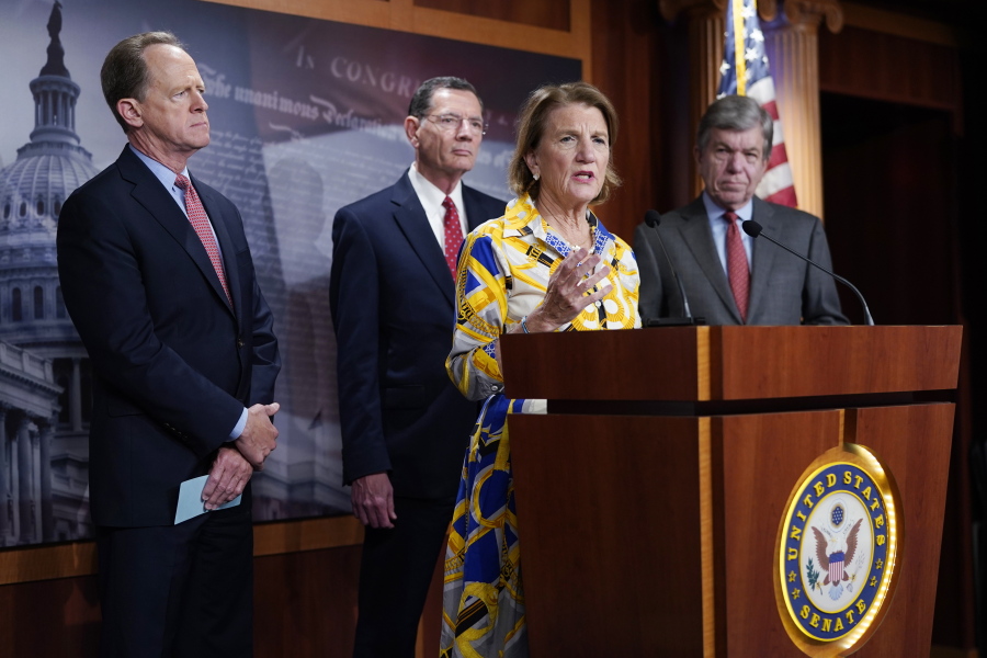 Sen. Shelley Moore Capito speaks at the Capitol in Washington, Thursday, May 27, 2021, as from left, Sen. Pat Toomey, R-Pa., Sen. Barrasso, R-Wy. and Sen. Roy Blunt, R-Mo., look on. Republican senators outlined a $928 billion infrastructure proposal Thursday, a counteroffer to President Joe Biden's more sweeping plan as the two sides struggle to negotiate a bipartisan compromise and remain far apart on how to pay for the massive spending. (AP Photo/J.