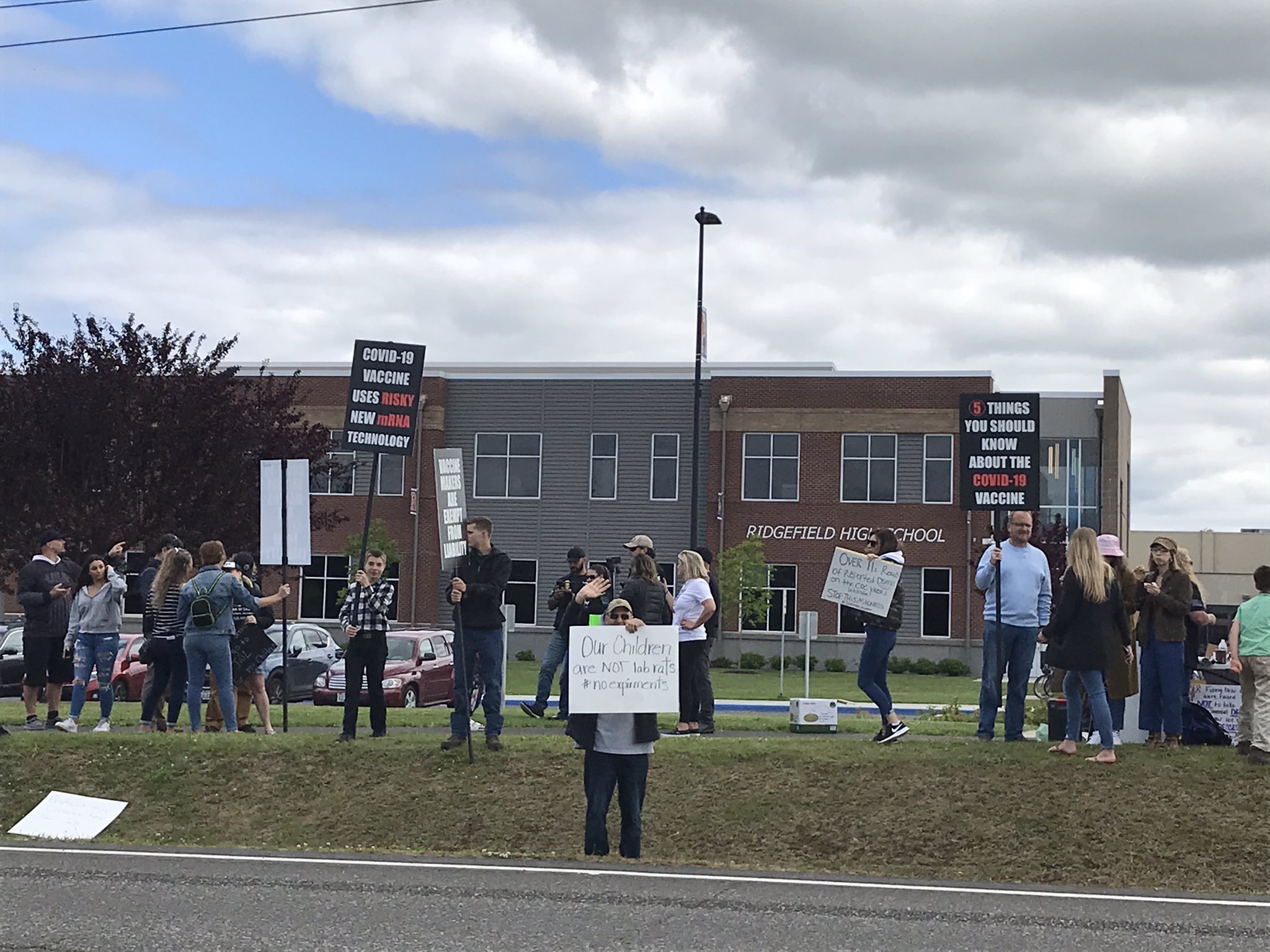Anti-vaccination protesters gather outside Ridgefield High School, which is hosting a COVID-19 vaccination clinic organized by students today.