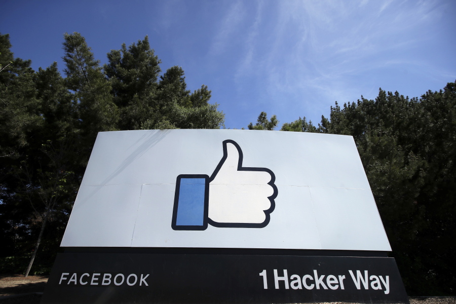 FILE - In this April 14, 2020 file photo, the thumbs up Like logo is shown on a sign at Facebook headquarters in Menlo Park, Calif. Facebook's oversight board, which on Wednesday, May 5, 2021 upheld the company's ban of former President Donald Trump, also had some harsh words for its corporate sponsor: Facebook. But critics aren't convinced this decision is a triumph of accountability, and say its actions may actually distract from more fundamental issues that Facebook seems less interested in talking about.