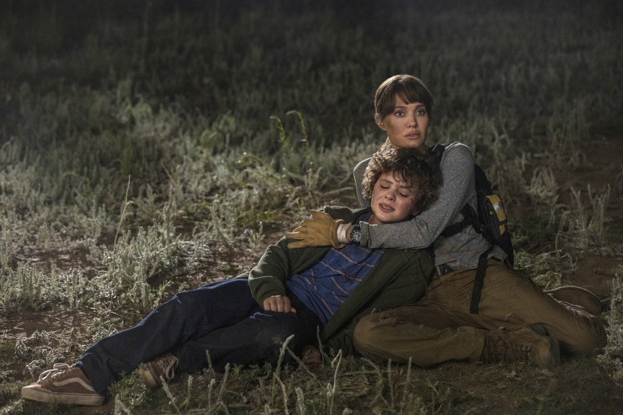 This image released by Warner Bros. Entertainment shows Angelina Jolie and Finn Little in a scene from "Those Who Wish Me Dead." (Emerson Miller/Warner Bros.