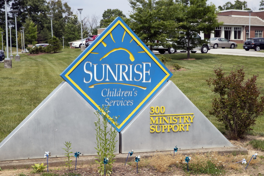 A sign for Sunrise Children's Services sits in front of the agency's Mount Washington, Ky., location on May 26, 2021. A cultural clash pitting religious beliefs against gay rights has jeopardized Kentucky's long-running relationship with a foster care and adoption agency affiliated with the Baptist church, Sunrise Children's Services, which serves some of the state's most vulnerable children.