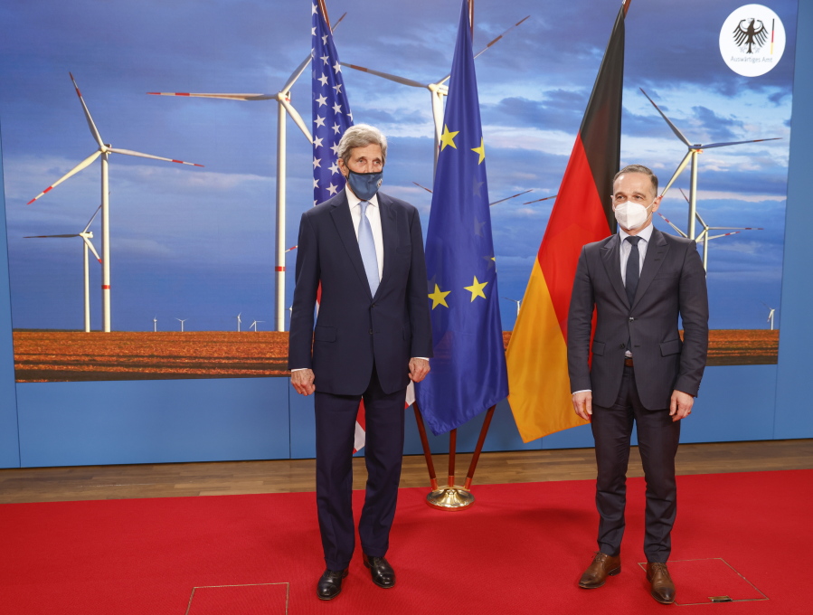 German Foreign Minister Heiko Maas, right, and the US' Special Presidential Envoy for Climate John Kerry, left, pose prior to a meeting at the Foreign Office in Berlin on Tuesday, May 18, 2021.