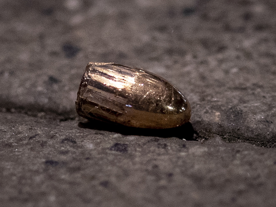 FILE - In this Feb. 19, 2020 file photo, a projectile lies on the sidewalk near a restaurant at the scene of a shooting in central Hanau, Germany. About one year ago a far right man shot nine people before he shot himself. Hanau will commemorate the victims this Friday.