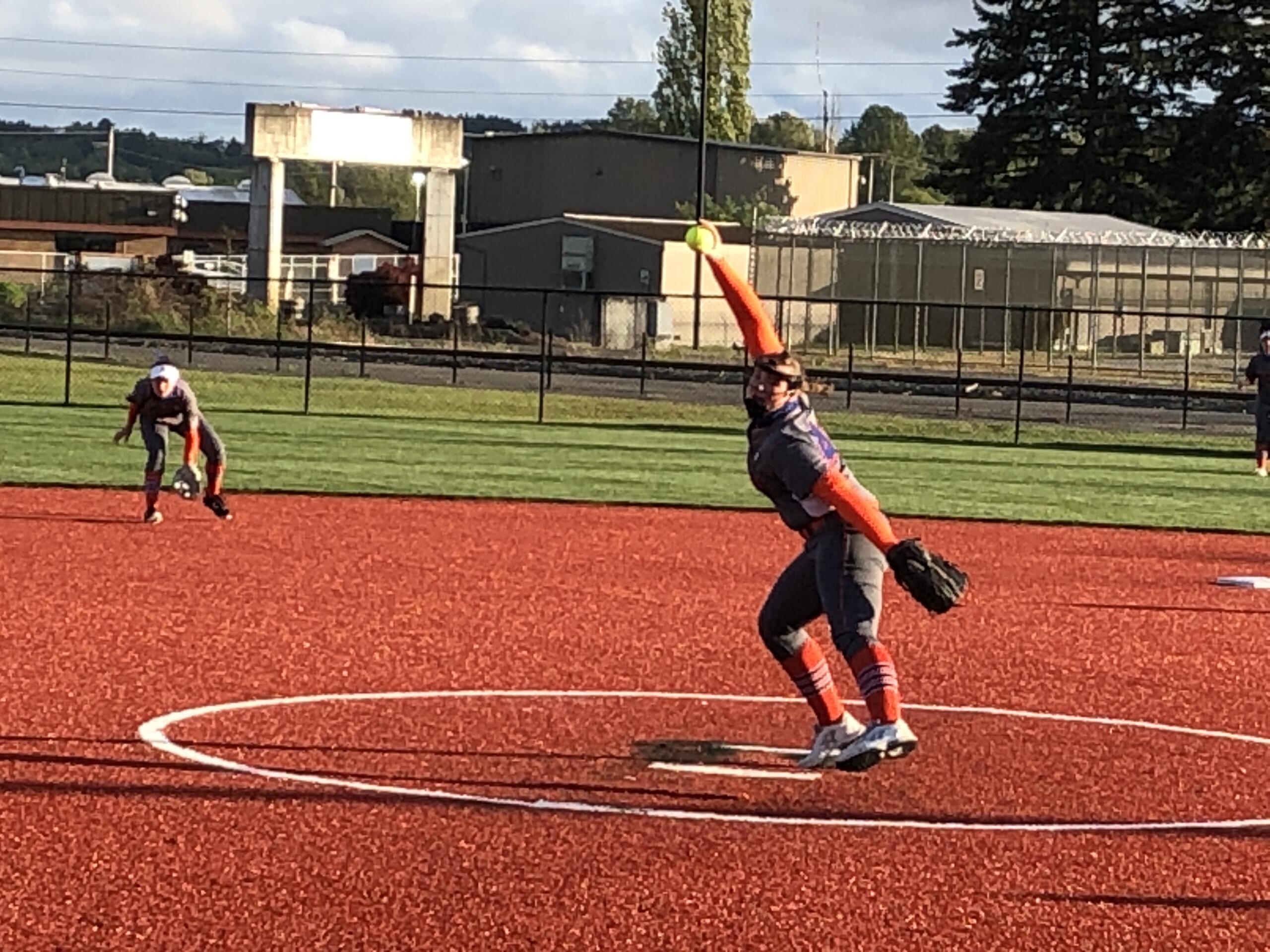 Ridgefield's Maizy Whitlow delivers a pitch against Columbia River in the third-place game of the 2A district softball tournament on Thursday at Recreation Park in Chehalis.