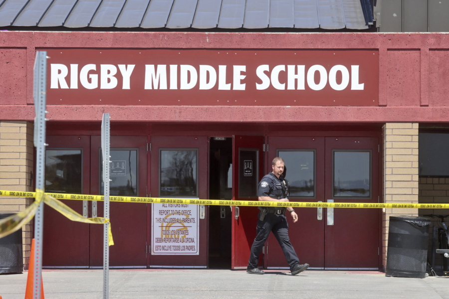A police officer walks out of Rigby Middle School in Rigby, Idaho, following a shooting there on May 6.