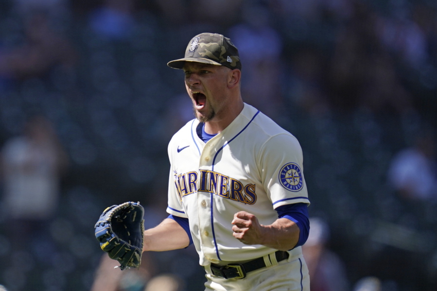 Seattle Mariners relief pitcher Anthony Misiewicz lets out a yell and pumps a fist after a double play with bases loaded ended the top of the seventh inning of a baseball game against the Cleveland Indians Sunday, May 16, 2021, in Seattle.