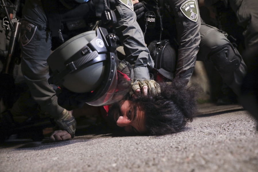 Israeli police officers detain a Palestinian demonstrator during a protest against the planned evictions of Palestinian families in the Sheikh Jarrah neighborhood of east Jerusalem, Tuesday, May 4, 2021.